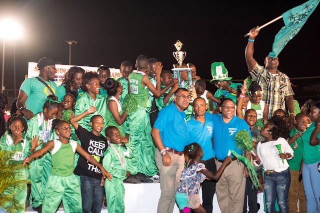 Victorious and jubilant St. Thomas Primary School athletes in the Class A Division of the 25th Gulf Insurance Primary School Championships, with Gulf Insurance Limited representatives, school staff and supporters at the trophy ceremony at the Elquemedo T. Willett Park on April 05, 2017 (photo courtesy Corner Stone)